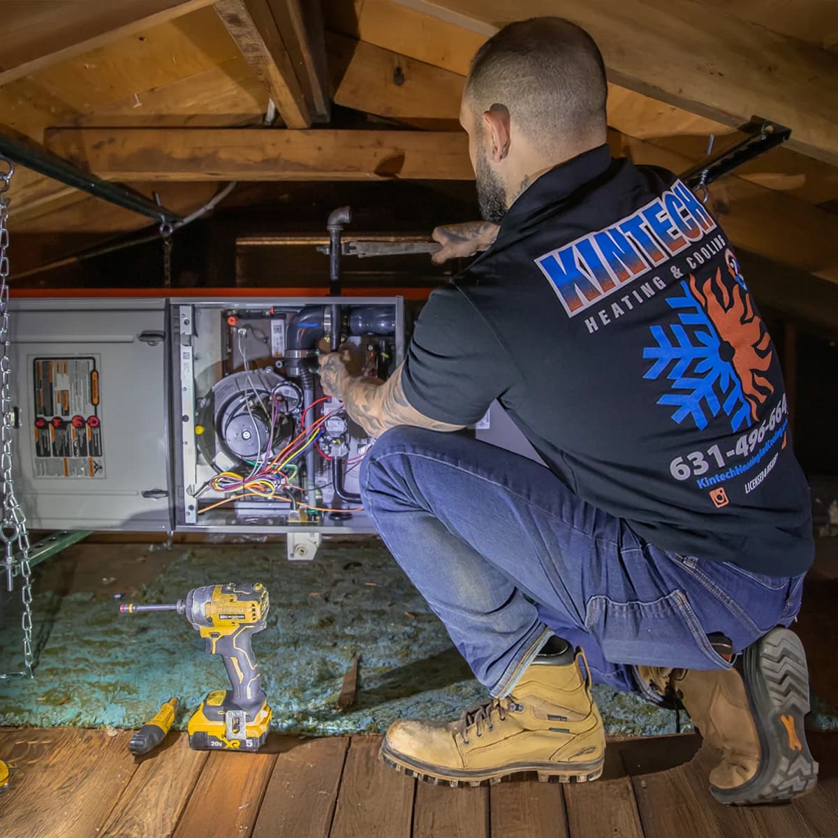 Kintech technician working on an open furnace in an attic