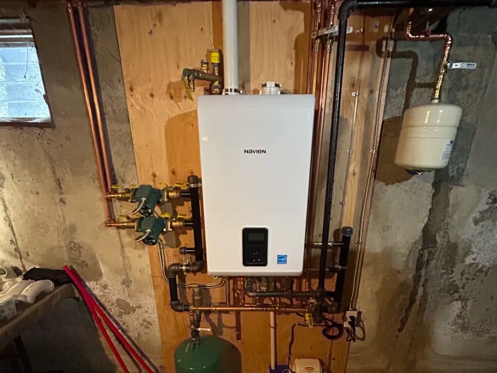 A finished Kintech tankless water heater installation in a Long Island basement