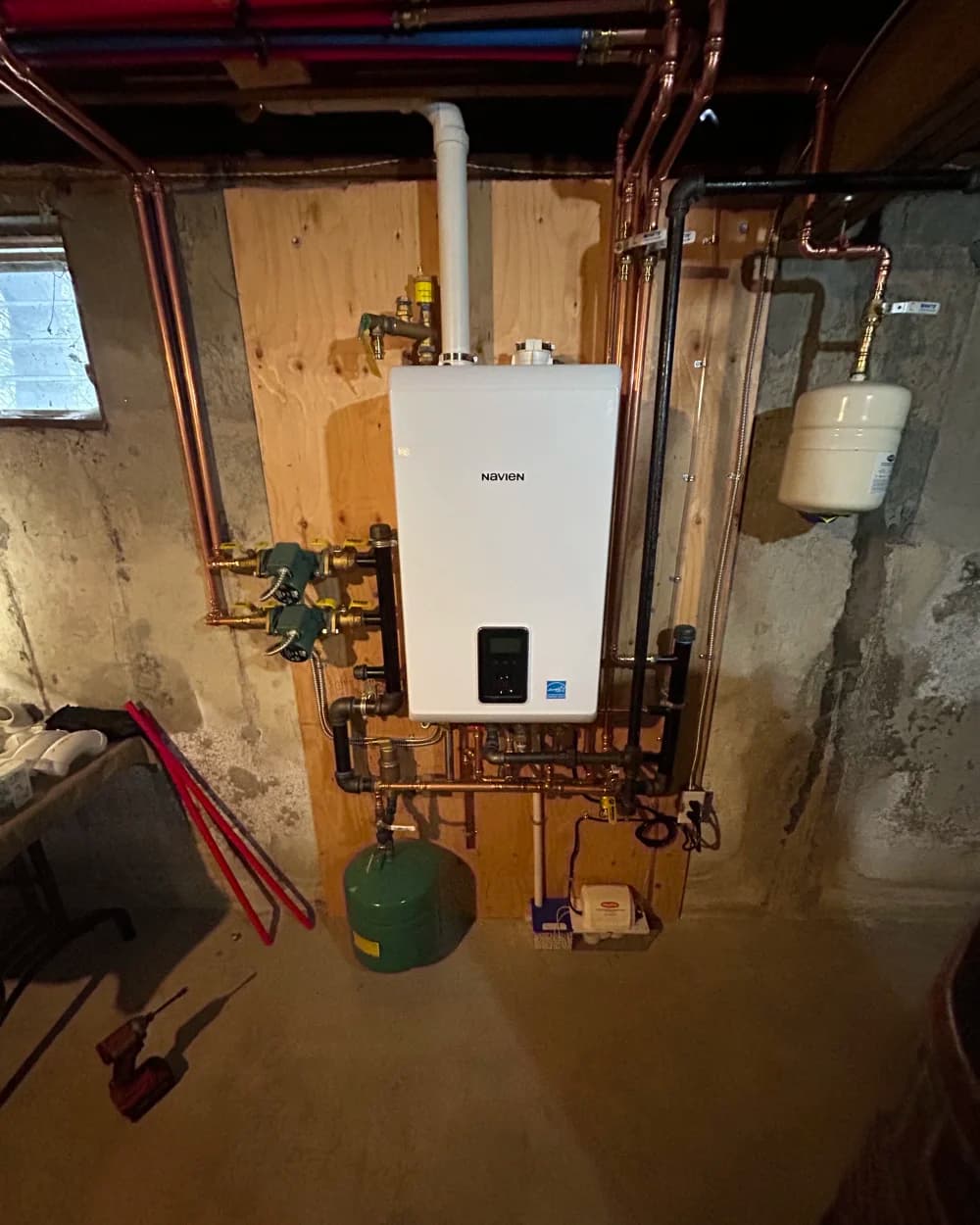 A finished Kintech tankless water heater installation in a Long Island basement