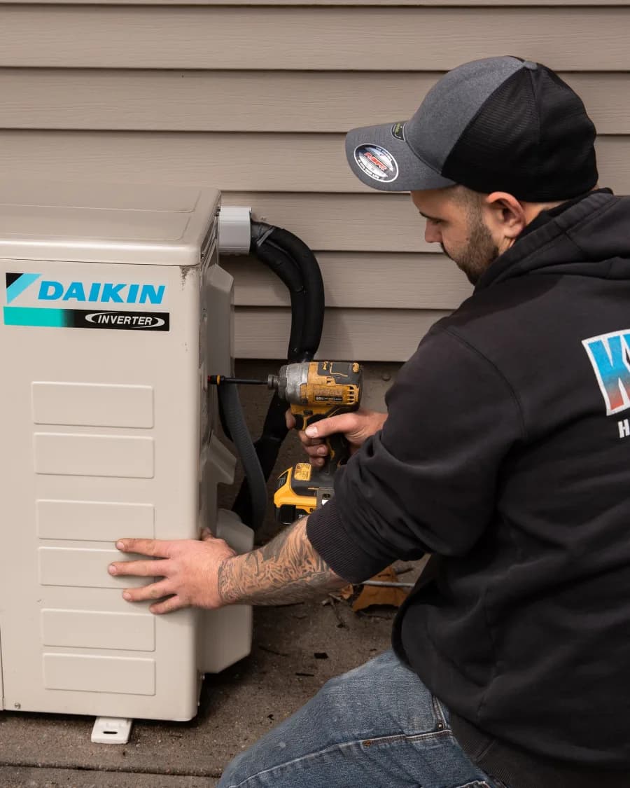 Kintech technician repairing a ductless mini-split outdoor unit