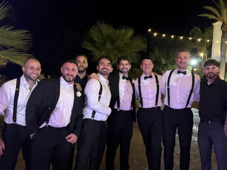 The Kintech crew dressed up for an evening out, arms around each other