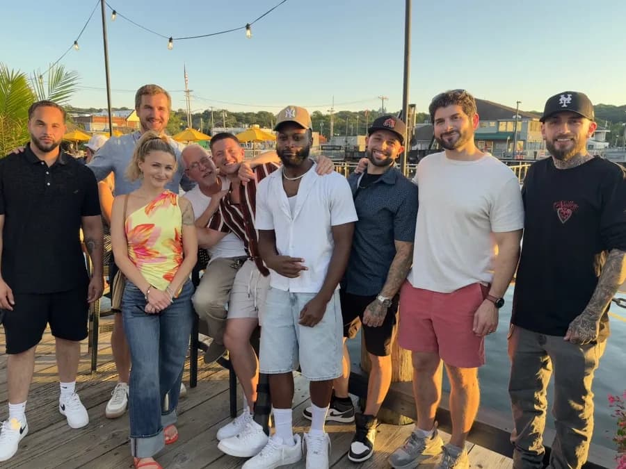The Kintech team together at a waterfront dinner on a summer evening