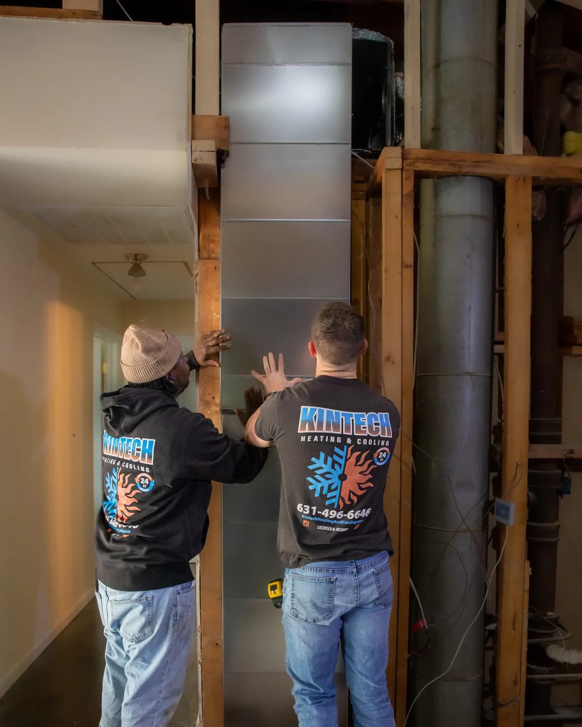 Two Kintech technicians fitting ductwork together